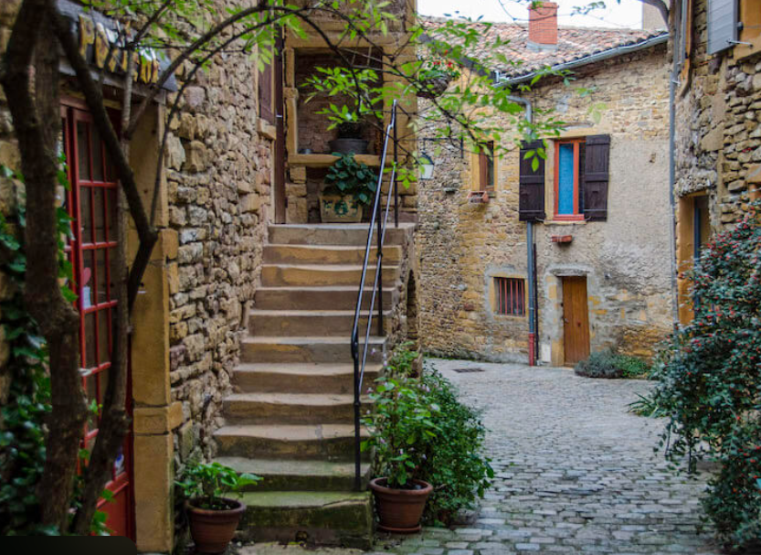 Cropped photo of the exterior of the top floor of an old stone building.
